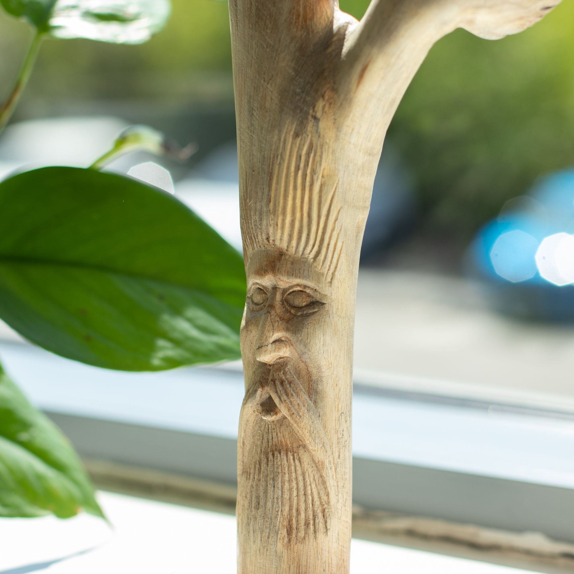 homme vert sculpté dans une branche en bois